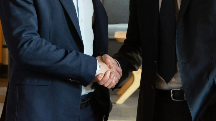 Two business partners shaking hands in agreement